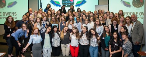 The Brooke Owens Fellowship cohort assembled under the programme’s winged-helmet logo.