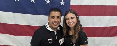 Payton Barnwell with a NASA astronaut in front of a United States flag.