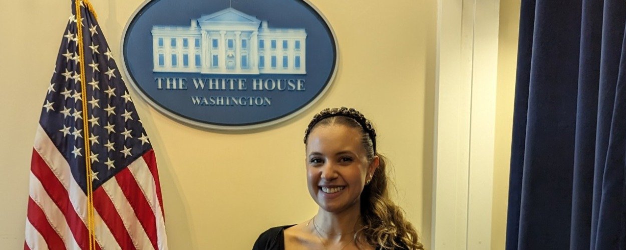 Payton Barnwell beside the White House seal and the flag.